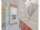 Bathroom with walk-in shower, updated vanity, and decorative mirror at 809 Lucia Dr, Punta Gorda, FL 33950