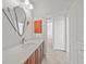 Clean bathroom with updated vanity, mirror, and access to other rooms at 809 Lucia Dr, Punta Gorda, FL 33950