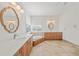 Bright bathroom with double vanity, soaking tub, and stylish light fixtures at 809 Lucia Dr, Punta Gorda, FL 33950