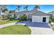 House exterior with a large driveway and landscaping at 809 Lucia Dr, Punta Gorda, FL 33950