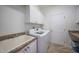 Bright laundry room with washer, dryer, cabinets, and utility sink at 809 Lucia Dr, Punta Gorda, FL 33950
