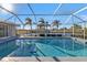 Inviting screened pool with dolphin tile accents and canal view at 9509 St Paul Dr, Port Charlotte, FL 33981