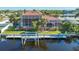 Back view of home showcasing canal access and a private dock at 108 Roselle Ct, Port Charlotte, FL 33952