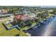 Aerial view of waterfront home with private dock and lush landscaping at 108 Roselle Ct, Port Charlotte, FL 33952