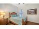 Cozy bedroom with a queen-size bed and hardwood floors at 108 Roselle Ct, Port Charlotte, FL 33952