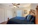 Bedroom with a wooden bed frame, ceiling fan, and ample closet space at 108 Roselle Ct, Port Charlotte, FL 33952