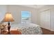 Bright bedroom with double doors and a leafy patterned bedspread at 108 Roselle Ct, Port Charlotte, FL 33952