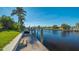 Wooden walkway leads to a private boat dock on the canal at 108 Roselle Ct, Port Charlotte, FL 33952
