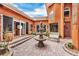 Inviting courtyard with fountain, brick paving, and seating area at 108 Roselle Ct, Port Charlotte, FL 33952