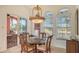 Elegant dining room with a glass-top table and access to a patio at 108 Roselle Ct, Port Charlotte, FL 33952