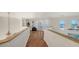 Upper hallway with hardwood floors, built-in shelves, and access to a balcony at 108 Roselle Ct, Port Charlotte, FL 33952