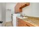 Laundry room with washer, dryer and wood cabinets at 108 Roselle Ct, Port Charlotte, FL 33952