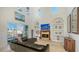 Spacious living room with a fireplace, high ceilings, and access to a patio at 108 Roselle Ct, Port Charlotte, FL 33952