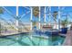 Enclosed pool and spa with blue tile accents and a tranquil atmosphere at 108 Roselle Ct, Port Charlotte, FL 33952