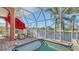 Relaxing pool area with screened enclosure and patio furniture at 108 Roselle Ct, Port Charlotte, FL 33952
