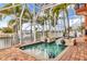 Enclosed pool and spa with lion head fountains and brick patio at 108 Roselle Ct, Port Charlotte, FL 33952