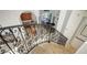 Ornate staircase with wrought-iron railing overlooking the kitchen at 108 Roselle Ct, Port Charlotte, FL 33952