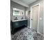 Modern bathroom with double vanity, patterned floor, and updated fixtures at 1196 Hinton St, Port Charlotte, FL 33952