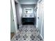 Updated bathroom with double vanity, patterned floor, and mirror at 1196 Hinton St, Port Charlotte, FL 33952