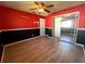 Bedroom with red and black walls and wood-look tile flooring at 1196 Hinton St, Port Charlotte, FL 33952
