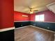 Bedroom with red and black walls and wood-look tile flooring at 1196 Hinton St, Port Charlotte, FL 33952