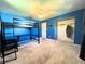 Bedroom with blue walls, carpet flooring, and a built-in bunk bed at 1196 Hinton St, Port Charlotte, FL 33952