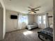 Bright bedroom featuring two beds, ceiling fan, and large window at 1196 Hinton St, Port Charlotte, FL 33952