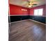 Bedroom with red and black walls and wood-look tile flooring at 1196 Hinton St, Port Charlotte, FL 33952