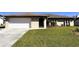 Front view of a single-story house with a neatly kept lawn at 1196 Hinton St, Port Charlotte, FL 33952