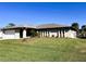 Single story house with a two-car garage and landscaped yard at 1196 Hinton St, Port Charlotte, FL 33952
