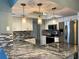 Granite kitchen island with stainless steel appliances and pendant lighting at 1196 Hinton St, Port Charlotte, FL 33952