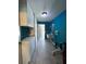 Laundry room with teal walls, white cabinets, and a utility sink at 1196 Hinton St, Port Charlotte, FL 33952