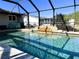 Refreshing screened pool with stone waterfall feature at 1196 Hinton St, Port Charlotte, FL 33952