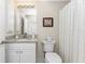 Clean bathroom with granite countertop, white cabinets, and shower at 17513 Pomegrante Way, Punta Gorda, FL 33955