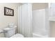 Simple bathroom with a tub shower and white tile at 17513 Pomegrante Way, Punta Gorda, FL 33955