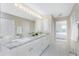 Bathroom boasts double sinks, granite countertops, and a tiled floor at 17513 Pomegrante Way, Punta Gorda, FL 33955
