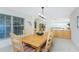 Bright dining room with built-in cabinetry and view to living room at 17513 Pomegrante Way, Punta Gorda, FL 33955