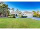 Single-story home with tile roof, landscaping, and two-car garage at 17513 Pomegrante Way, Punta Gorda, FL 33955