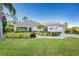 Single-story home with tile roof, landscaped yard, and driveway at 17513 Pomegrante Way, Punta Gorda, FL 33955