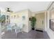 Inviting front porch entryway with seating and ceiling fan at 17513 Pomegrante Way, Punta Gorda, FL 33955