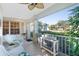 Relaxing screened porch with wicker seating and view of the street at 17513 Pomegrante Way, Punta Gorda, FL 33955