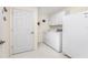 Laundry room with washer, dryer, and extra storage at 17513 Pomegrante Way, Punta Gorda, FL 33955