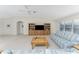 Open living room with vaulted ceiling and built-in entertainment center at 17513 Pomegrante Way, Punta Gorda, FL 33955