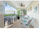 Relaxing screened porch with wicker chairs and ceiling fan at 17513 Pomegrante Way, Punta Gorda, FL 33955