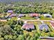 Bird's-eye view of a single-Gathering home in a residential neighborhood with surrounding houses and trees at 1858 Capitol St, North Port, FL 34288