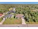 Single-Gathering home with a driveway and green lawn, situated in a residential area with trees at 1858 Capitol St, North Port, FL 34288