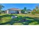 Spacious backyard with fire pit and lush landscaping at 1858 Capitol St, North Port, FL 34288