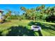 Large backyard with firepit and tropical landscaping at 1858 Capitol St, North Port, FL 34288