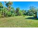 Expansive backyard with lush tropical landscape at 1858 Capitol St, North Port, FL 34288