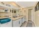 Double vanity bathroom with granite countertop and large mirror at 1858 Capitol St, North Port, FL 34288